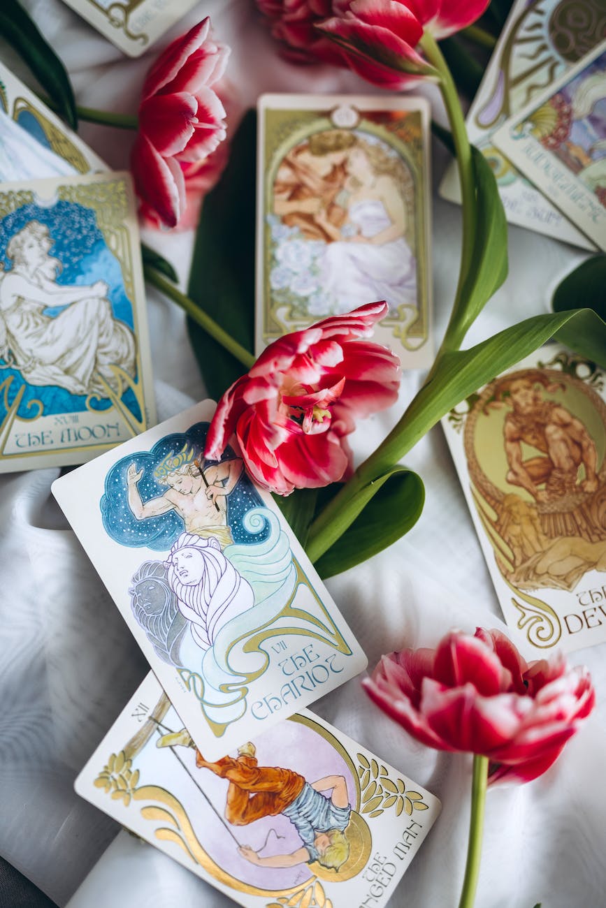 tarot cards lying among red tulips