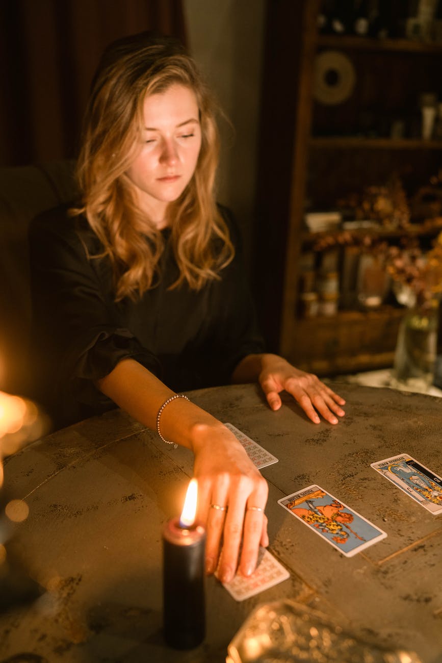 a woman flipping a tarot card on the table